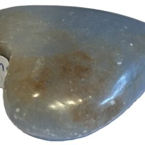 Polished natural angelite carved heart crystal 1 sians emporium Smooth polished blue angelite carved heart crystal showing natural white mineral flecks on a white background